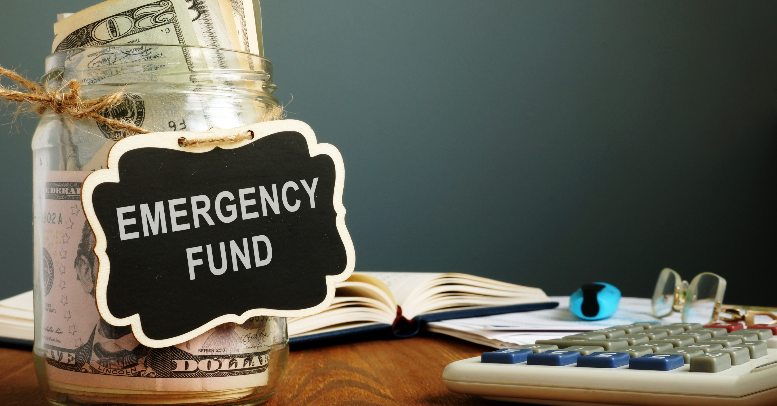 Cash in jar with emergency fund label 